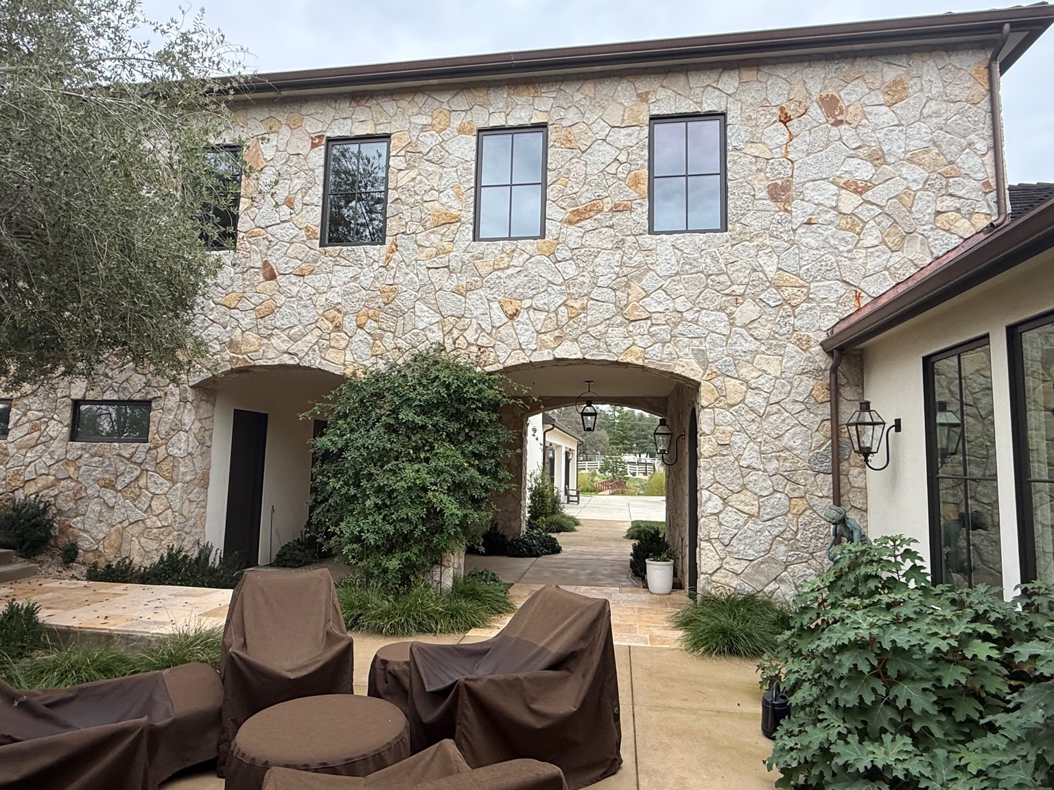 Stone archway courtyard by Dave's Masonry